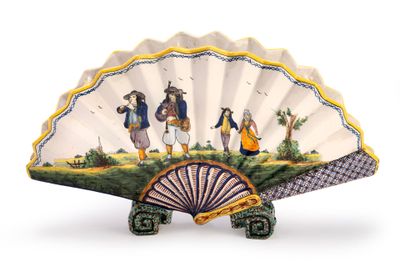 a decorative fan with a painting of people on it