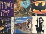 many different album covers on the wall