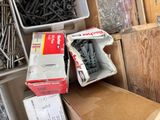 a box of screws and a box of screws on the floor