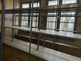 a room with a lot of tables and benches in it