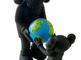a small statue of an elephant and a small statue of a bear holding a globe