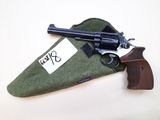a gun that is laying on top of a green bag