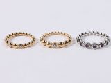 three gold and silver rings on a white background