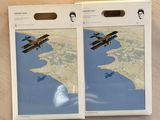 two boxes of air planes are sitting on a wooden table