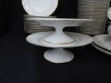 a stack of plates and a cake plate on a table