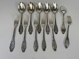 a lot of silver spoons and forks on the table
