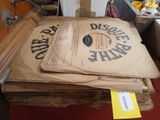 a stack of brown paper bags sitting on top of a suitcase