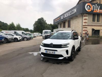 a white suv parked in front of a building