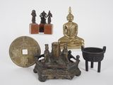 a small statue of buddha sitting on a table next to other items