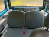 a seat in the back of a van with a red button