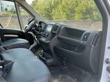 the interior of a white van with black leather seats and a steering wheel