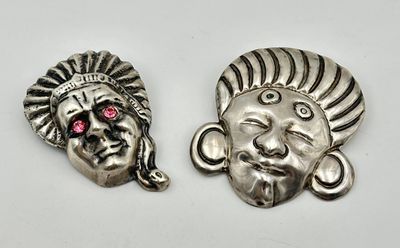 a pair of silver and pink stone indian head charms