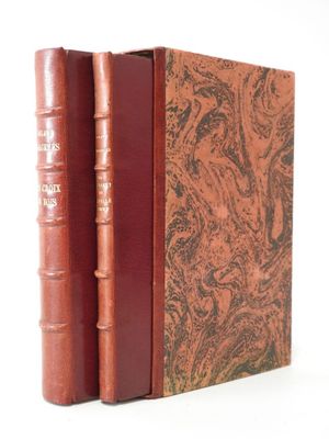 two books sitting on top of each other on a white surface
