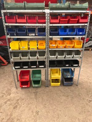 many different bins on the shelves in the garage