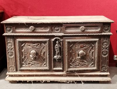 a wooden chest with carvings on it in a room