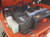 an orange car with a bunch of batteries in the trunk