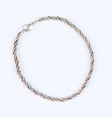 a close up of a silver bracelet on a white background