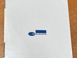 a white box with a blue dot logo on it sitting on a wooden table