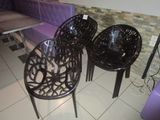 three plastic chairs sitting on a tiled floor in a room