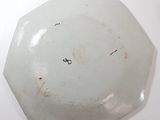 a white plate with a black design on it