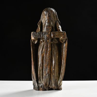 statue of a woman holding a cross on a white surface