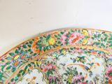 a decorative plate with flowers and birds on it