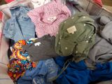 a suitcase full of clothes and a teddy bear in it