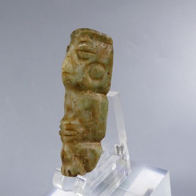 sculpture of a head on a clear base on a white background
