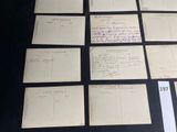 some old postcards are sitting on a table with a lot of writing