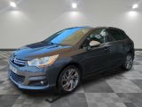 a grey citrole is parked on a checkered tile floor