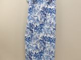 a blue and white floral dress hanging on a hanger