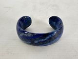 lapis bracelet with a blue marbled surface on a white surface