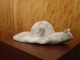 a sculpture of a snail sitting on top of a wooden box