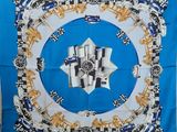 a close up of a blue and white square scarf with a picture of a car