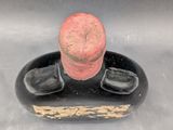 a black and red figurine of a man with a red hat