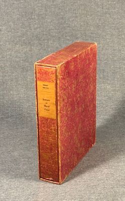 a red book sitting on top of a gray surface