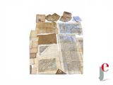 a pile of old maps on a white surface