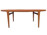 the table is made of teak and has a curved top