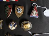 a lot of badges that are on a black table
