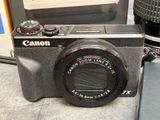 a black camera sitting on a table next to a camera