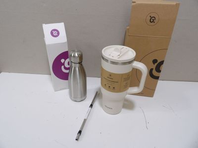 a coffee mug and a pen sitting on a table