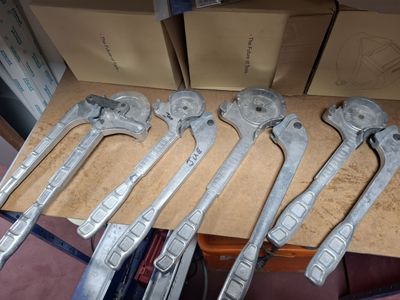five wrenches that are sitting on top of a table