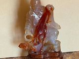 a figurine of a man and a woman sitting on a rock