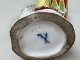a close up of a vase with a flower on it