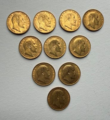 a close up of a bunch of gold coins on a white surface