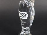 a close up of a glass owl figurine on a black surface