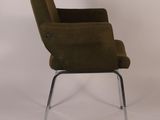an image of a green chair with chrome legs