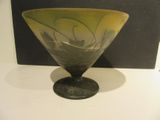 a glass bowl sitting on a table next to a black box