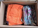 a box full of clothes that is sitting on the floor