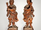 pair of carved wood figures of a boy and a girl